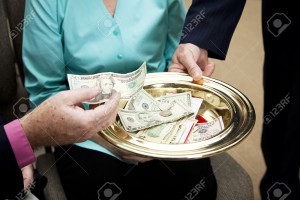 8097956-Church-members-putting-money-in-the-collection-plate--Stock-Photo